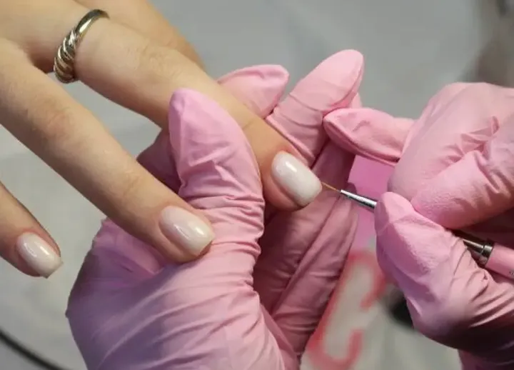 Nail technician working on a manicure