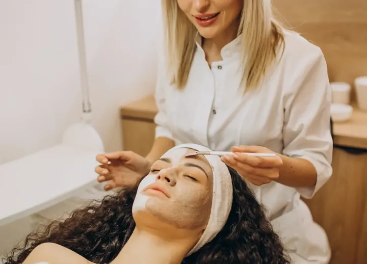 Skin specialist treating a client's face