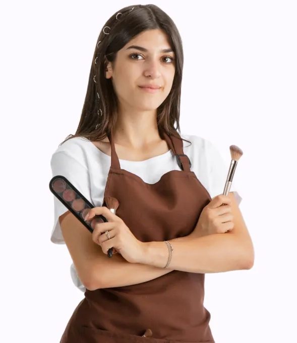 Beauty professional holding a makeup palette and brush
