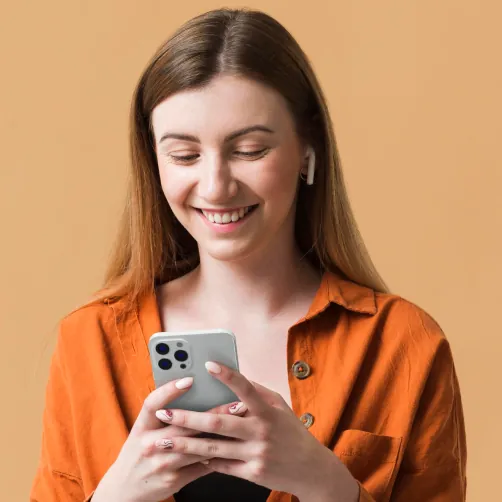 Smiling client booking a salon appointment on her phone